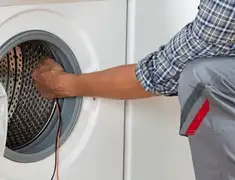 Dryer repair technician diagnosing and servicing a clothes dryer in Rochester, NY