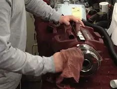 Vacuum repair technician cleaning and servicing a vacuum motor in Rochester, NY
