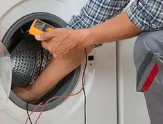 Washing machine repair technician testing a front-load washer with diagnostic tools in Rochester, NY